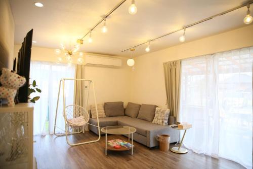 a living room with a couch and a table at KOTOVilla JR琴平駅近く丸々貸切一棟室内アスレチック in Kotohira