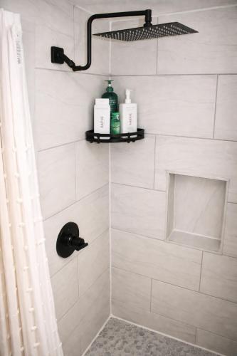 a bathroom with a shower with white tiles at Mohegan Sun Getaway Large Group Retreat in Danielson