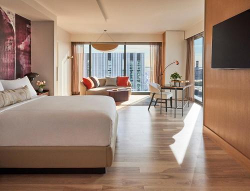 a bedroom with a bed and a living room at Omni Boston Hotel at the Seaport in Boston