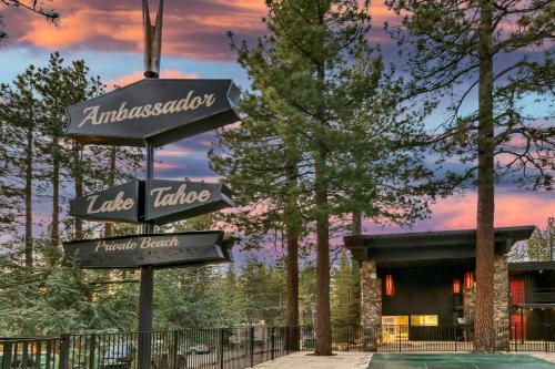 a sign in front of a house with trees at Ambassador Lake Tahoe in South Lake Tahoe