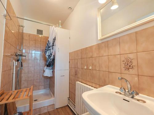 a bathroom with a sink and a shower and a tub at Maison avec parking - 7 pers. - FR-1-591-784 in Éguzon-Chantôme
