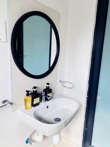a bathroom with a sink and a mirror at The Exec Place Maun in Maun