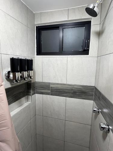 a bathroom with a shower with a window at Casa Legado in Orizaba
