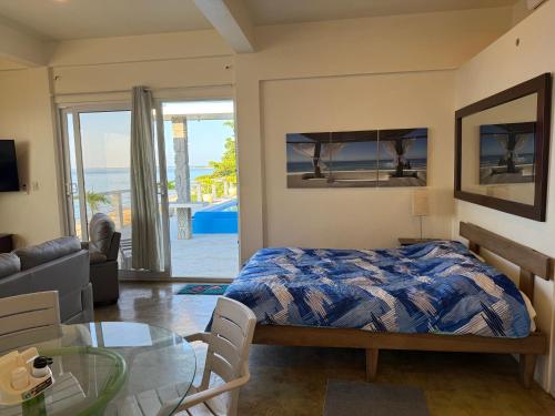 a bedroom with a bed and a glass table at Tranquility Bay Beach Retreat in Trujillo