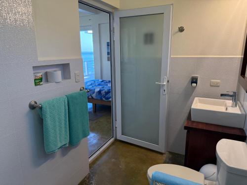 a bathroom with a sink and a toilet and a shower at Tranquility Bay Beach Retreat in Trujillo
