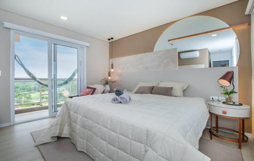 a bedroom with a large white bed and a large window at Luxury3BRLagoonView Beach BBQ in San Bernardino