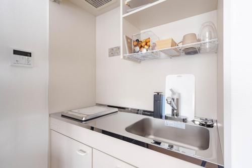 a kitchen with a sink and a mirror at アンドステイ屋形町507 in Kyoto