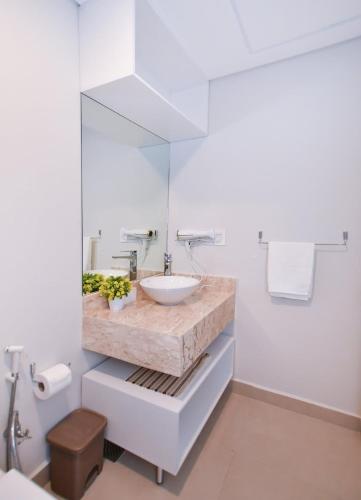 a white bathroom with a sink and a mirror at Work & Relax 1BR Amenities in Fernando de la Mora