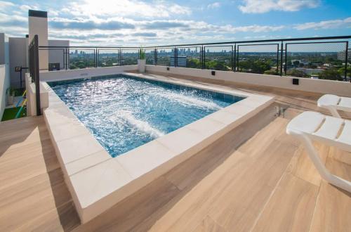 a swimming pool on the roof of a building at Cozy 1BR Desk Pool & Terrace in Fernando de la Mora