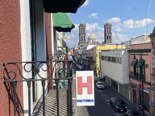 a view of a city street from a balcony at Hotel Victoria in Puebla