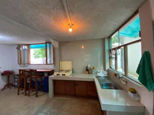 a kitchen with a sink and a counter top at El Barquero in Puerto Baquerizo Moreno