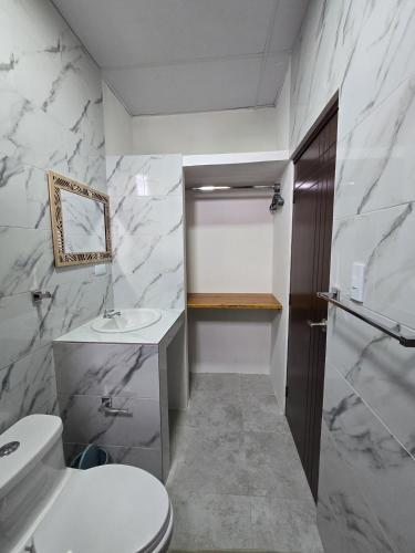 a bathroom with a toilet and a sink at Hammerhead Shark Apartment in Puerto Baquerizo Moreno