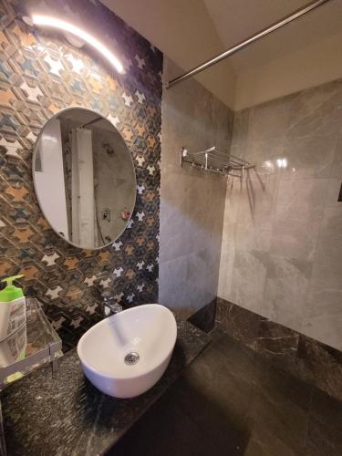 a bathroom with a sink and a mirror at Alhaad valley views in Mulshi