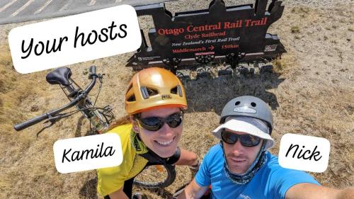 two men are standing next to a truck with signs at Ranfurly Hostel with Sauna in Ranfurly
