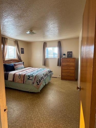 a bedroom with a bed and a dresser at Lakeside Dune Getaway in Lakeside