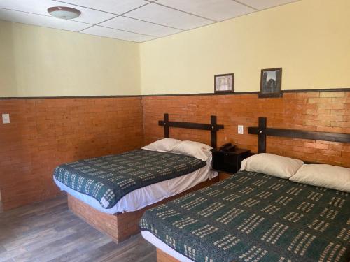 a room with two beds in a room at Hotel San Agustin in Puebla