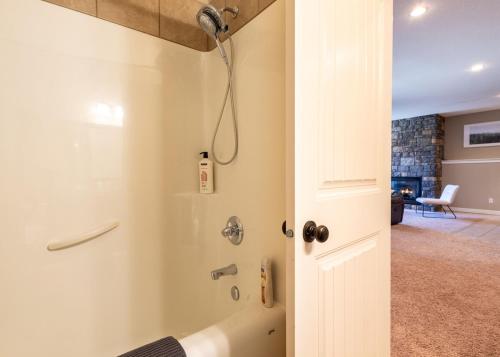 a bathroom with a shower with a glass door at Serenity suite in Lethbridge