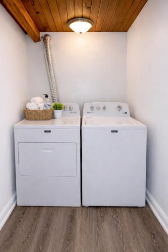 two white washers and a sink in a laundry room at Game Room Fun Extended Stay Friendly in Danielson