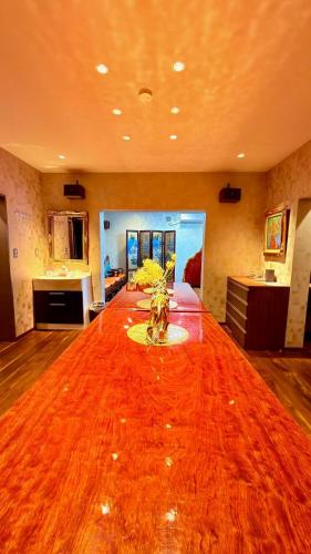 a large living room with a large orange rug on the floor at House KIMIJIMA in Yachimata