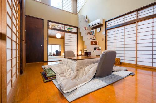 a living room with a couch and a table at Spacious Traditional Japanese House with Modern Amenities near Shibuya for Families and Groups up to 8 Guests in Tokyo