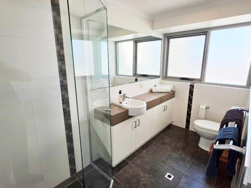 a bathroom with a sink and a toilet at Waves at Jurien, Villa 9-23 Dalton Street in Jurien Bay