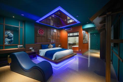 a bedroom with a large bed and a blue lighting at Chiic House Hải Phòng in Lực Hánh