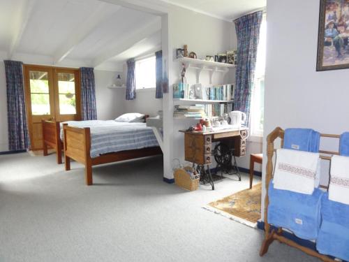a bedroom with a bed and a desk at Mairenui Rural Retreat in Ruahine