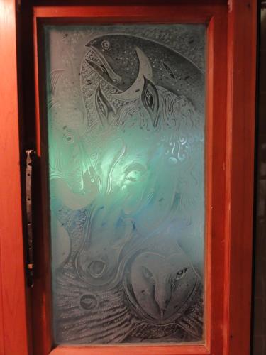 a glass door with a painting of a fish at Mairenui Rural Retreat in Ruahine