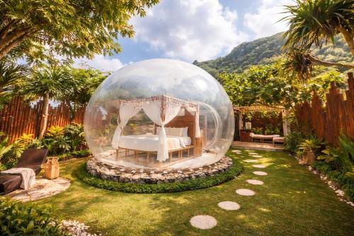 a bedroom in a bubble in a garden at Bubble 4 - Romantic With Bath Uluwatu in Uluwatu