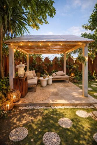 a pergola with a bench in a yard at Bubble 4 - Romantic With Bath Uluwatu in Uluwatu