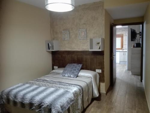 a bedroom with a bed and a hallway at Los Zafranales in Codo