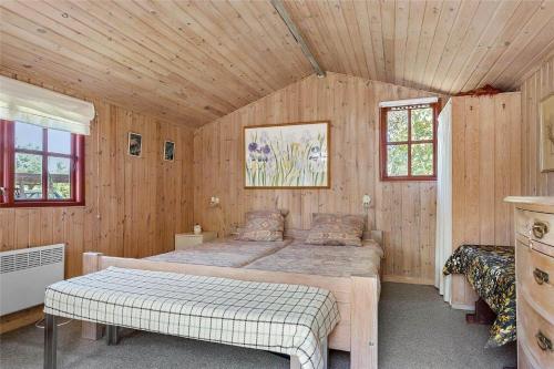 a bedroom with two beds in a room with wooden walls at SL078-Slagelse-Dybkaervej-36 in Slagelse