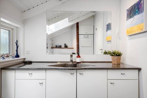 a white kitchen with a sink and a mirror at 30305-Ulfborg-Bellisvej-504 in Ulfborg
