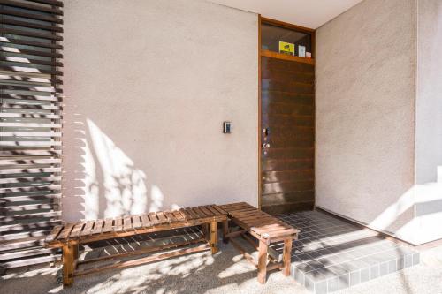 a wooden bench sitting outside of a building at Spacious Traditional Japanese House with Modern Amenities near Shibuya for Families and Groups up to 8 Guests in Tokyo