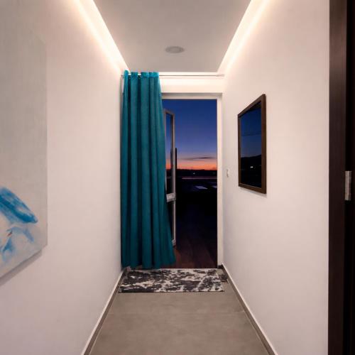 a hallway with a green curtain in a room at Moonlit Terrace Escape in St. Paul's Bay