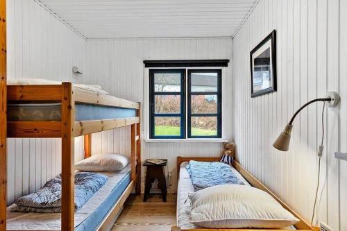 a bedroom with two bunk beds and a window at SB122-Augustenborg-Gronvej-3 in Asserballeskov