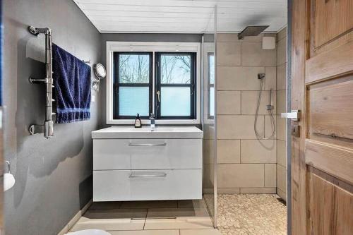 a bathroom with a white sink and a shower at SB122-Augustenborg-Gronvej-3 in Asserballeskov