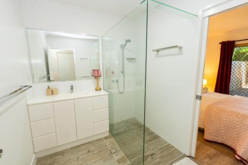 a bathroom with a shower and a sink at Jara - U19 Pandanus Palms Resort in Point Lookout