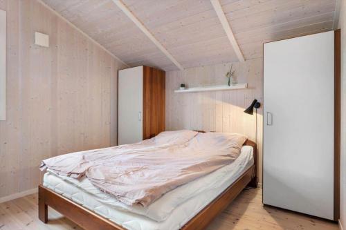 a bedroom with an unmade bed and a closet at LF12022-Spottrup-Skovmarken-2 in Vadum