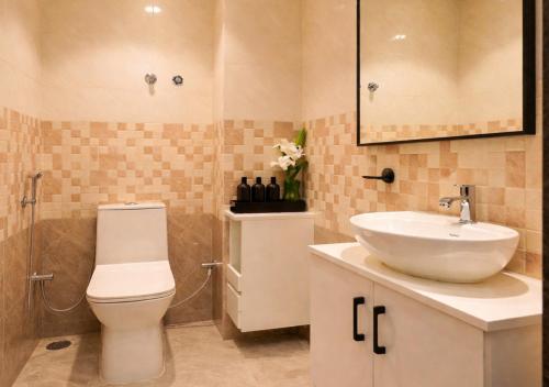 a bathroom with a toilet and a sink at Nivara Stays Lingampalli, A Boutique Hotel Brand in Hyderabad