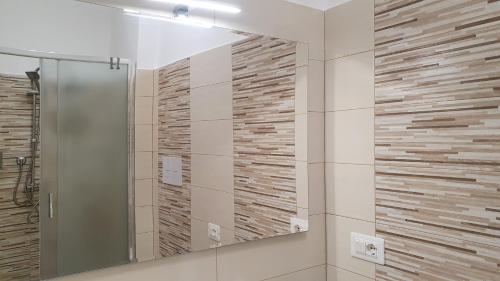 a bathroom with a mirror and a shower at CasAmare in Montesilvano