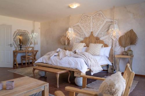 a bedroom with a large bed with a wooden headboard at Art Cabin Beach Villa in Langstrand