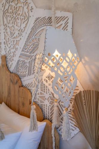 a chandelier hanging from the ceiling of a bedroom at Art Cabin Beach Villa in Langstrand