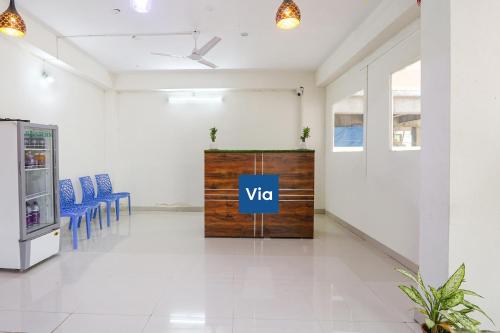a room with blue chairs and a vico sign on a door at Via Dream Connect - Narsingi in Hyderabad
