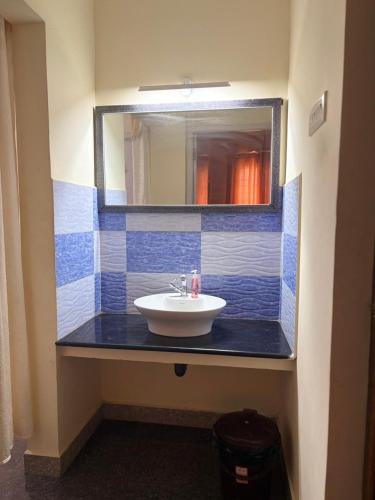 a bathroom with a sink and a mirror at Serenity Beach House in Pondicherry