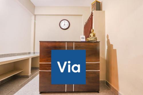 a vita sign on a podium in a room with a clock at Via Prestige Castle - Nr HITEX Exhibition Center Hitech City in Hyderabad