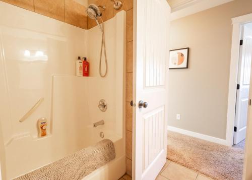 a bathroom with a tub and a shower stall at Opulent Oasis in Lethbridge