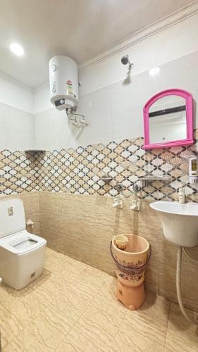 a bathroom with a toilet and a sink at Hotel M Palace Unit Of MDP Ayodhya Near Rammandir in Ayodhya