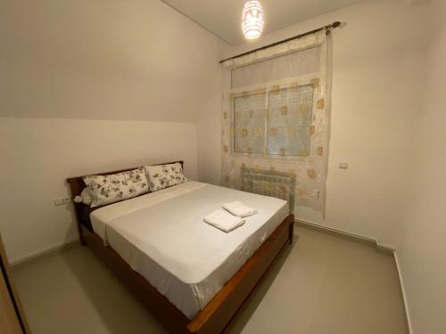 a bedroom with a bed in a room with a window at Cedar Peak Residence in Ifrane