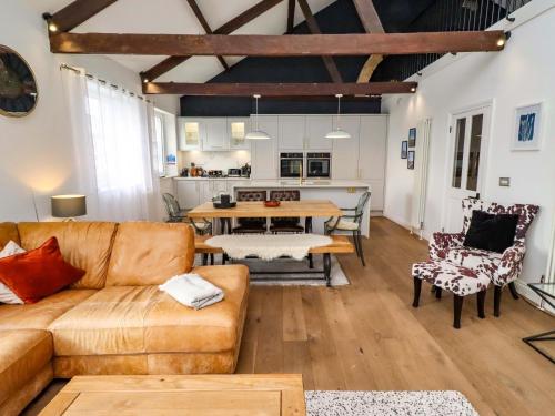 a living room with a couch and a table at Treetops, Alnwick in Alnwick